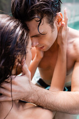 selective focus of woman touching shirtless man