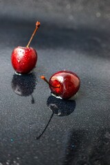 Bright juicy ripe cherry on a dark background.