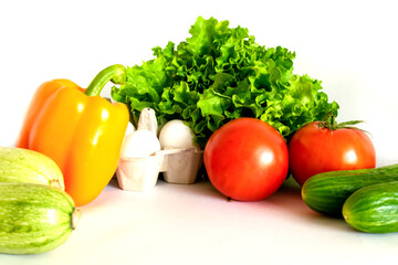 Assortment of healthy food, fresh green red organic vegetables on a white background.
