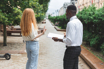 The woman refuses to take part in a public poll or survey. Woman gestures with hand as rejection