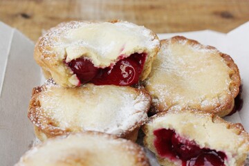 Delicious cupcakes with cherry jam on the table 