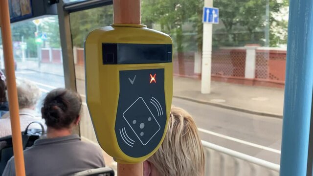 Ticket validator faulty, card reader in public transport. Device scanning of public transport cards to pay for riding. Red lights signal in the form of a cross. Device error 4k