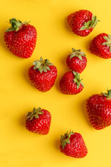 Obraz na płótnie Canvas strawberries at yellow minimal background