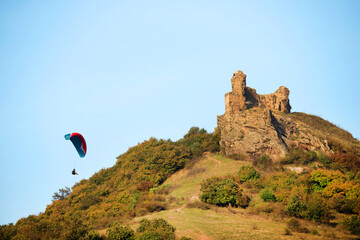 Paraglider flying over the hills