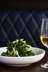 Kale Salad with Green Apple on Wooden Table
