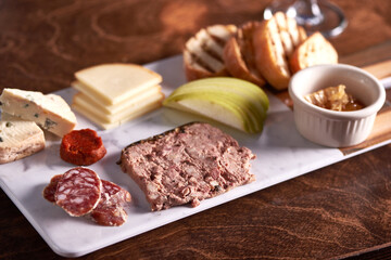 Charcuterie Meat and Cheese Plate on Marble and Wood