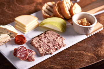Charcuterie Meat and Cheese Plate on Marble and Wood