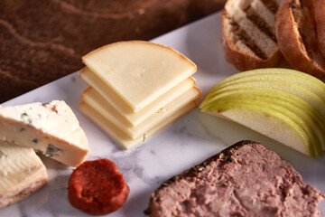 Charcuterie Meat and Cheese Plate on Marble and Wood