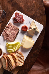 Charcuterie Meat and Cheese Plate on Marble and Wood