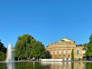 Fototapeta na wymiar The Stuttgart State Theatre Opera building and fountain in Eckensee lake, Germany.