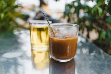 iced coffee with milk and hot tea in Vietnamese style on table. Selective Focus.