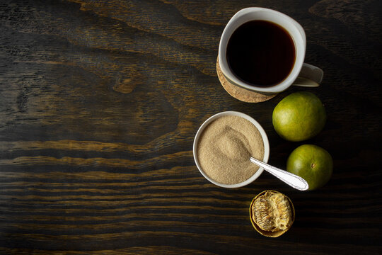 dried monk fruit, luo han guo, and monk fruit sugar crystals accompanied with a cup of tea or coffee