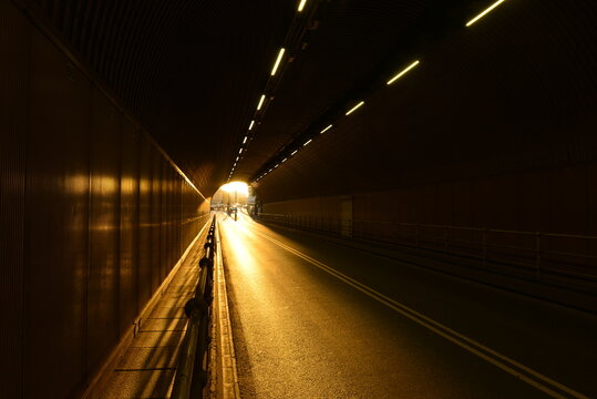 Road tunnel, Jersey, U.K. Sun setting at entrance of passage.