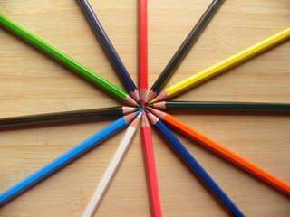 Fototapeta premium Many color pencils arranged in circle kept on wooden table