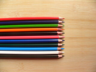 Fototapeta premium Many color pencils kept on wooden table