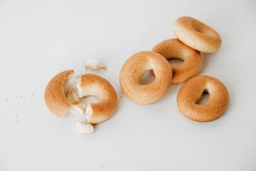 Drying or mini round bagels on a white wooden background. Copy, empty space for text