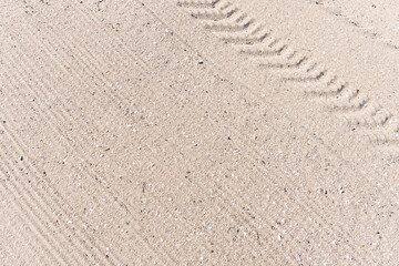 Sand beach background with Truck trail on cleaning surface
