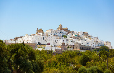 Fototapeta na wymiar Panoramic view of the white and old city of Ostuni on a hilltop and with the cathedral on top