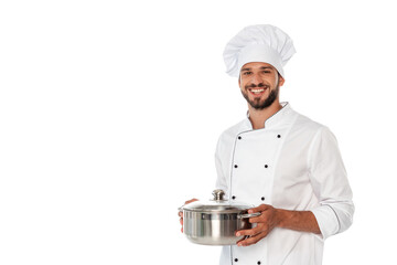 Handsome chef smiling at camera while holding pan isolated on white