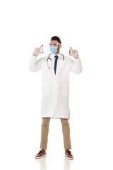 Doctor in safety goggles and mask holding test tubes with blood samples on white background