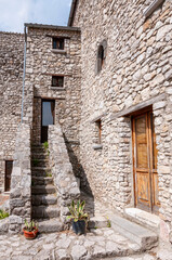Fototapeta na wymiar A narrow street between the old houses of a medieval village in Riardo Italy