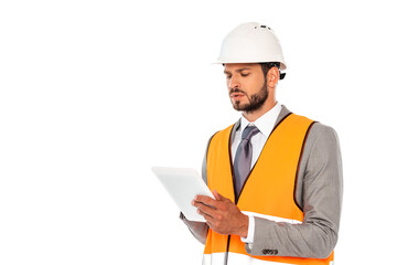 Handsome engineer in suit and safety vest using digital tablet isolated on white