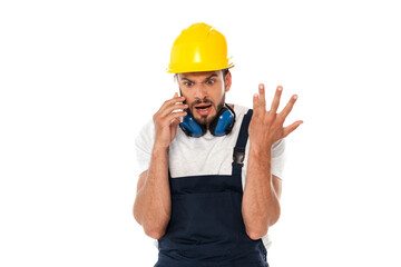 Angry workman gesturing while talking on smartphone isolated on white
