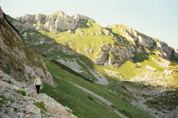 Young Caucasian woman traveling in the mountains of Durmitor National Park in Montenegro. Real grain scanned film.