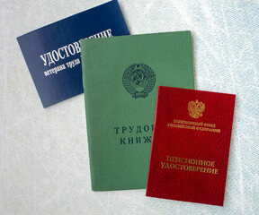 Documents of a Russian pensioner. Background with an old-style work book, a pension certificate and...