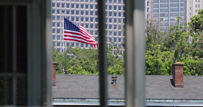 American flag waves over Governors Island in New York City on a clear day.