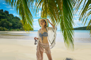  girl wearing a bikini on the beach by the seaUntitled