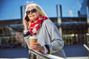 Happy cheerful female talking on her mobile phone