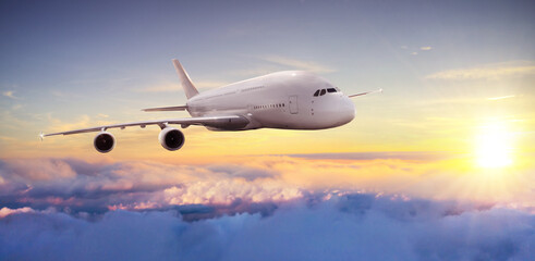 Naklejka na ściany i meble Huge commercial airplane flying above clouds