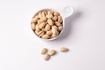 Pistachios in a white ceramic cup