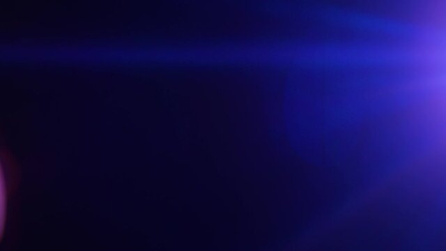 Short blue anamorphic lens flare moving down the right side of frame.