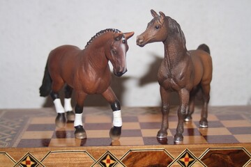 Toy horses on a chess board
