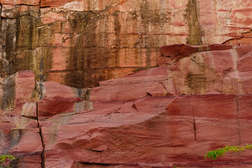 Sandstone forms when layers of sand accumulates by sedimentation are compacted & cemented by precipitation of minerals within pore spaces of sand grains. Red color is imparted by Hematite Iron oxide.