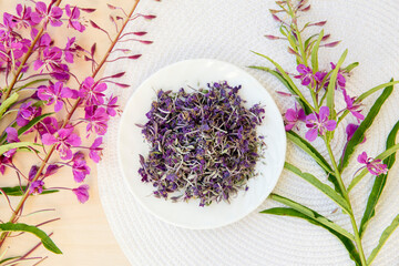 Flat lay view and selective focus on dried Chamaenerion angustifolium( fireweed, great willowherb, rosebay willowherb) with fresh blossoms for decoration. Herbal medicine concept.