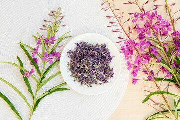 Flat lay view and selective focus on dried Chamaenerion angustifolium( fireweed, great willowherb, rosebay willowherb) with fresh blossoms for decoration. Herbal medicine concept.