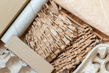 Fototapeta na wymiar shredded, cut paper, carton for recycling inside a cardboard box. Ecology background.