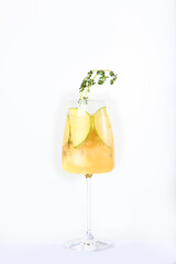 Green Apple lemonade in a tall glass glass. Soft drink. Vertical photo on a white background. Copy of the space. An isolated object.
