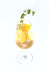 Green Apple lemonade in a tall glass glass. Soft drink. Vertical photo on a white background. Copy of the space. An isolated object.
