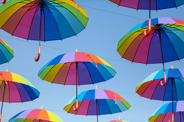 Umbrellas in the color of the rainbow against the  sky.