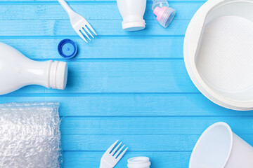White plastic waste for recycling on blue background