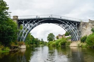 The Iron Bridge at Ironbridge, spanning the River Severn, viewed from low level along the river