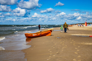 an orange lifeguard boat on a beach in Łeba in Poland on a warm  day