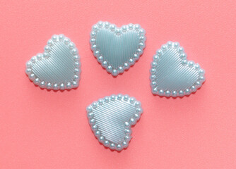 Blue hearts on a pink background.
