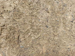 Off-road. Close-up footprints in the mud. Dirty path after the rain. Country road after the rain. Traces of shoes in the mud. Bad dirt road. Abstract background, texture, pattern, material, wallpaper.