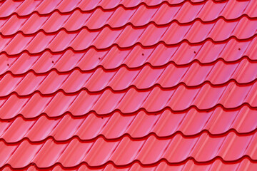 Red metal tile on the roof of the house