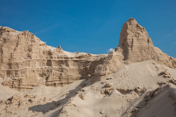 Fototapeta premium Heaps of sand washed up from the river that look like rocky mountains